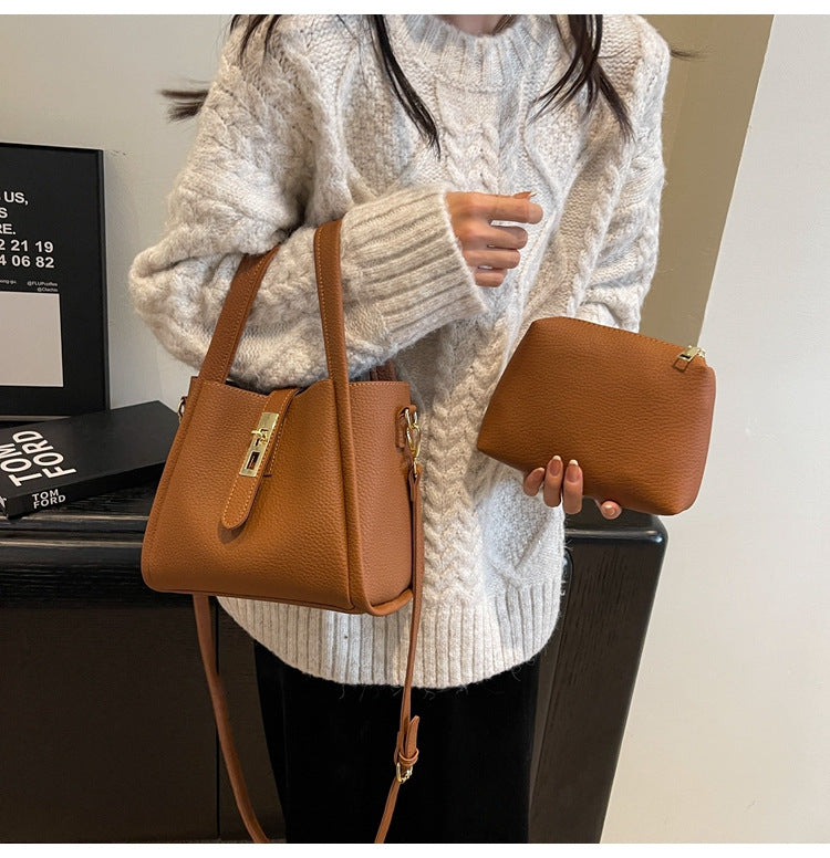 Women's Structured Handbag Featuring Top Handles and Gold Accents